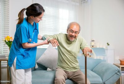 Young woman help support orthopedic patients to get up with walking cane at home, Caring nurse helping supporting senior disabled man to stand up with walking stick, International Day for the Elderly